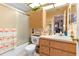 Well-lit bathroom features shower-tub combo, vanity and built-in cabinet with a toilet at 11511 113Th St # 35E, Largo, FL 33778