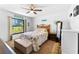 Comfortable bedroom showcasing a ceiling fan and a large window, with relaxing decor at 11511 113Th St # 35E, Largo, FL 33778