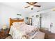 Inviting bedroom with a warm ambiance, enhanced by a ceiling fan and a coastal decor theme at 11511 113Th St # 35E, Largo, FL 33778