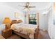 Comfortable bedroom features a queen-sized bed, ceiling fan, and closet for ample storage at 11511 113Th St # 35E, Largo, FL 33778