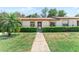 Charming single-story home with a well-manicured lawn and inviting walkway at 11511 113Th St # 35E, Largo, FL 33778