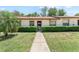 Inviting one-story home with a well-manicured lawn, trimmed hedges, and a welcoming entrance at 11511 113Th St # 35E, Largo, FL 33778