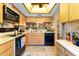 Efficient kitchen with wood cabinets, updated appliances, and a skylight providing natural light at 11511 113Th St # 35E, Largo, FL 33778
