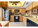 Functional kitchen featuring wood cabinets, modern appliances, and a cozy skylight at 11511 113Th St # 35E, Largo, FL 33778