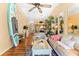 Bright living area featuring a ceiling fan, hardwood floors, and stylish beach themed decor at 11511 113Th St # 35E, Largo, FL 33778