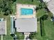 Aerial shot of community pool, showcasing crystal-clear water, lounge chairs, and a shuffleboard court at 11511 113Th St # 35E, Largo, FL 33778