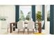 Sunlit dining room with a sleek table, modern chairs, and large windows at 11817 Sparkling Topaz Cv, Parrish, FL 34219