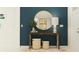 Stylish entryway featuring an accent wall, decorative mirror, and modern table at 11817 Sparkling Topaz Cv, Parrish, FL 34219