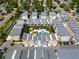 Aerial view showcasing townhomes with a central pool and community green spaces at 1182 25Th N Way, St Petersburg, FL 33713
