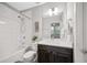 Well-lit bathroom with a shower-tub combo, dark wood vanity, modern fixtures, and light countertops at 1182 25Th N Way, St Petersburg, FL 33713
