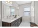 Bathroom with dual sinks, large mirror, and dark vanity for ample storage at 1182 25Th N Way, St Petersburg, FL 33713