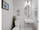 Charming half bathroom boasts coastal decor, decorative mirror, and sink at 1182 25Th N Way, St Petersburg, FL 33713