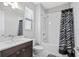 Modern bathroom with a tub and shower combination, stylish vanity, and a decorative shower curtain at 1182 25Th N Way, St Petersburg, FL 33713