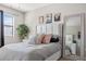 Bright bedroom with padded headboard, stylish decor, and a view from a large window at 1182 25Th N Way, St Petersburg, FL 33713