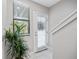 Bright entryway with white tiled floor, neutral walls, and a decorative plant welcoming you into this charming home at 1182 25Th N Way, St Petersburg, FL 33713