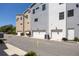 Rear exterior view of modern townhomes, each with a garage, under a clear blue sky at 1182 25Th N Way, St Petersburg, FL 33713