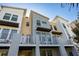 Modern townhome featuring a private balcony, clean lines, and neutral color palette, bathed in the warm sunlight of a clear blue sky at 1182 25Th N Way, St Petersburg, FL 33713