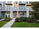 Inviting townhome facade with well-manicured landscaping, a private balcony, and a welcoming entrance at 1182 25Th N Way, St Petersburg, FL 33713