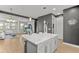 Kitchen island featuring granite countertops; living room with natural light in background at 1182 25Th N Way, St Petersburg, FL 33713