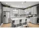 Modern kitchen features an island with white countertop and stainless steel appliances at 1182 25Th N Way, St Petersburg, FL 33713