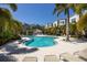 Resort-style community pool with palm trees, lounge chairs, and lush landscaping creating a relaxing atmosphere at 1182 25Th N Way, St Petersburg, FL 33713