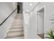 Modern staircase featuring light wood stairs, white trim, and neutral walls, creating a clean and inviting transition space at 1182 25Th N Way, St Petersburg, FL 33713