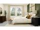 Inviting bedroom with a large window, neutral curtains, and a comfortable bed with decorative pillows at 11829 Sparkling Topaz Cv, Parrish, FL 34219