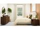 Cozy bedroom with large windows, an area rug, a dresser, and bedside tables at 11829 Sparkling Topaz Cv, Parrish, FL 34219
