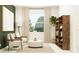 Cozy living room with armchairs, an ottoman, a large window, and a bookshelf, creating a relaxing atmosphere at 11829 Sparkling Topaz Cv, Parrish, FL 34219