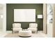 Relaxing living room with stylish chairs, soft lighting, and a large blank canvas for personalized decor at 11829 Sparkling Topaz Cv, Parrish, FL 34219