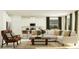 Inviting living room with modern furnishings, a comfortable sofa, and a kitchen view at 11829 Sparkling Topaz Cv, Parrish, FL 34219