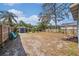Spacious backyard with a shed, wooden fence, and potential for landscaping and outdoor activities at 1207 E Giddens Ave, Tampa, FL 33603