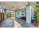 Cozy carport for a charming home, with brick pillars and a covered entrance to a quaint outdoor seating area at 1207 E Giddens Ave, Tampa, FL 33603