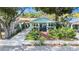 Charming home with inviting porch, lush landscaping, and a well-manicured front yard at 1207 E Giddens Ave, Tampa, FL 33603