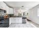 Modern kitchen showcasing stainless steel appliances, mosaic backsplash, and an open layout at 1207 E Giddens Ave, Tampa, FL 33603