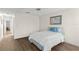 Bedroom with wood laminate flooring boasts a ceiling fan and a large window at 1218 Gillespie N Dr, Palm Harbor, FL 34684