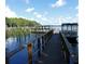 A wooden dock on a lake shows a boat at 1218 Gillespie N Dr, Palm Harbor, FL 34684