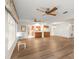 Living room with wood floors is part of an open-concept home that includes the dining room and kitchen at 1218 Gillespie N Dr, Palm Harbor, FL 34684