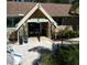 Charming lodge entrance with stone accents and manicured landscaping, offering a welcoming atmosphere at 1218 Gillespie N Dr, Palm Harbor, FL 34684