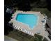 Aerial view of community pool with ample lounge chairs and umbrellas for residents to enjoy the Florida sunshine at 1218 Gillespie N Dr, Palm Harbor, FL 34684