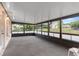 Spacious enclosed porch featuring windows offering views of the private backyard at 1218 Gillespie N Dr, Palm Harbor, FL 34684
