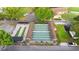 A high angle aerial shot highlights the community shuffleboard courts, the parking area and beautiful landscaping at 1218 Gillespie N Dr, Palm Harbor, FL 34684