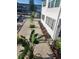 Well-maintained front yard with white gravel, flowerbeds, and tropical landscaping at 1221 Drew St # B17, Clearwater, FL 33755