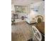 Bright living room featuring a stylish white sofa, wood floors, and a large decorative mirror at 1221 Drew St # B17, Clearwater, FL 33755