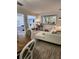 Open-concept living room with a sleek white sectional and stylish wood-look flooring at 1221 Drew St # B17, Clearwater, FL 33755
