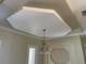 Elegant dining room featuring a tray ceiling, chandelier, and decorative molding at 13211 Park Blvd, Seminole, FL 33776