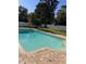 Private swimming pool with brick coping, perfect for relaxation and entertaining in a serene backyard setting at 13211 Park Blvd, Seminole, FL 33776