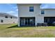 Exterior view of the back of the home featuring a screened in porch with comfortable seating at 138 Mangrove Shade Cir, Apollo Beach, FL 33572