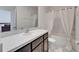 Bathroom features a granite countertop vanity and a tub with shower for a relaxing spa environment at 138 Mangrove Shade Cir, Apollo Beach, FL 33572