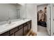 Bathroom with double vanity, large mirror, and walk-in closet offer space and convenience at 138 Mangrove Shade Cir, Apollo Beach, FL 33572